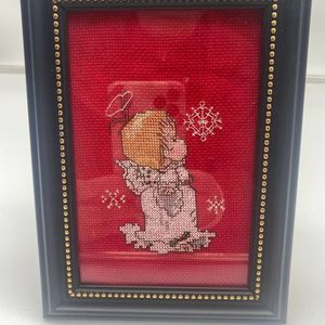 Picture cross stich of an angle in a frame with stand on back side